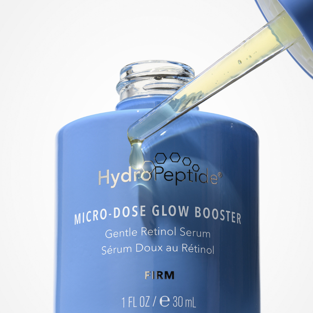 Blue HydroPeptide serum bottle with dropper on a white background