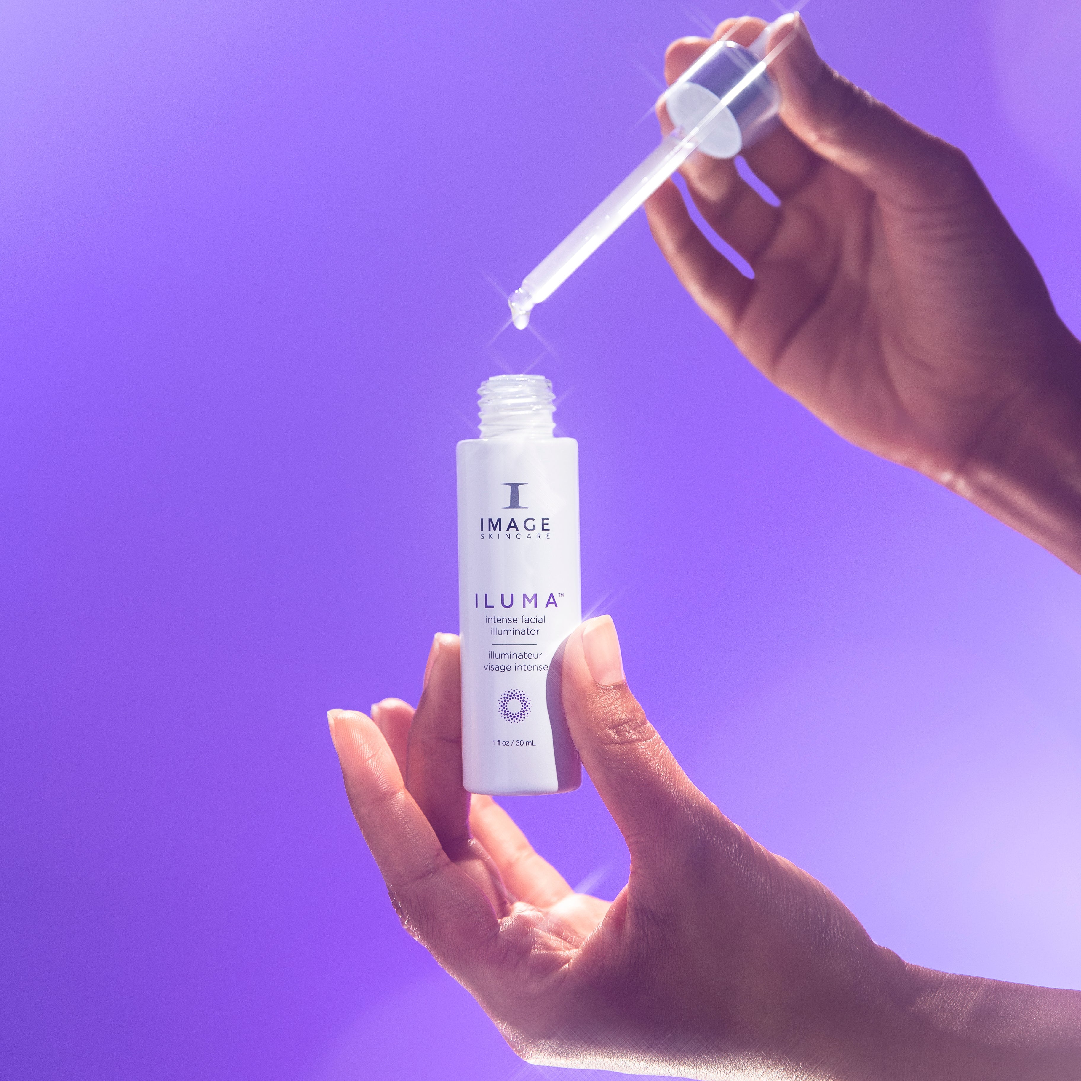Hand holding a dropper over a bottle labeled 'Iluma' against a purple background