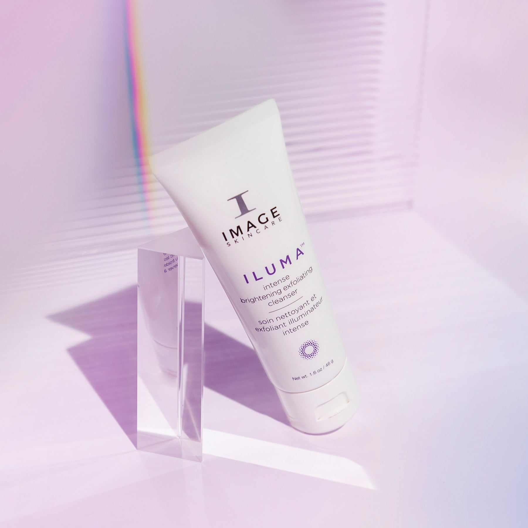 Tube of Image Skincare Iluma on a light purple background with a rainbow effect