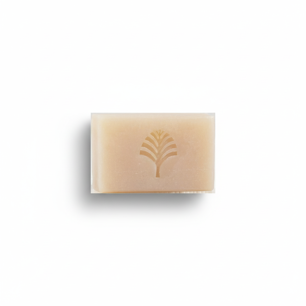 Beige bar of soap with a tree logo on a white background