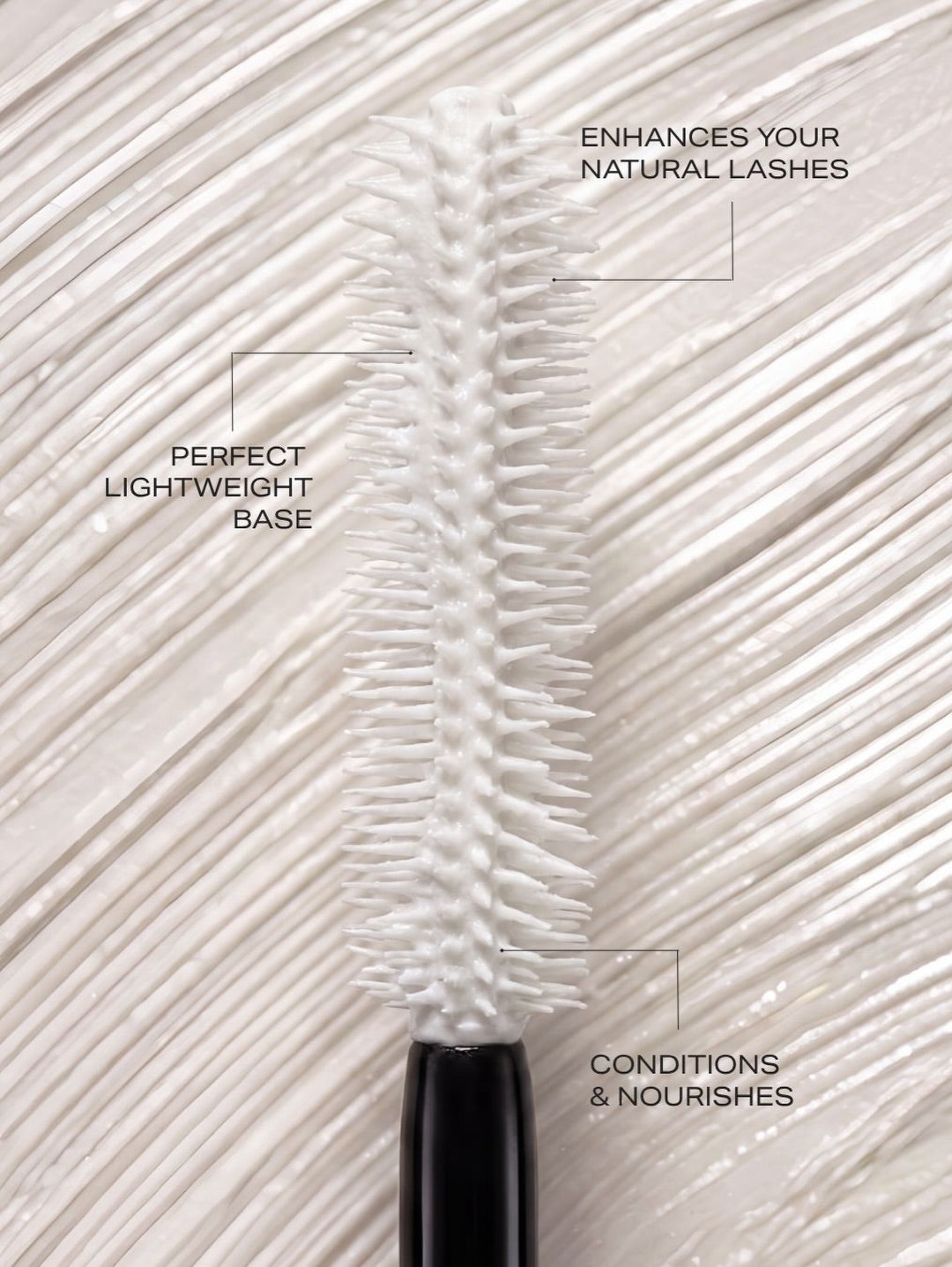 A close-up of a Youngblood Primer mascara wand with white bristles and a black handle, shown against a textured white lash background with callout text describing lash benefits.