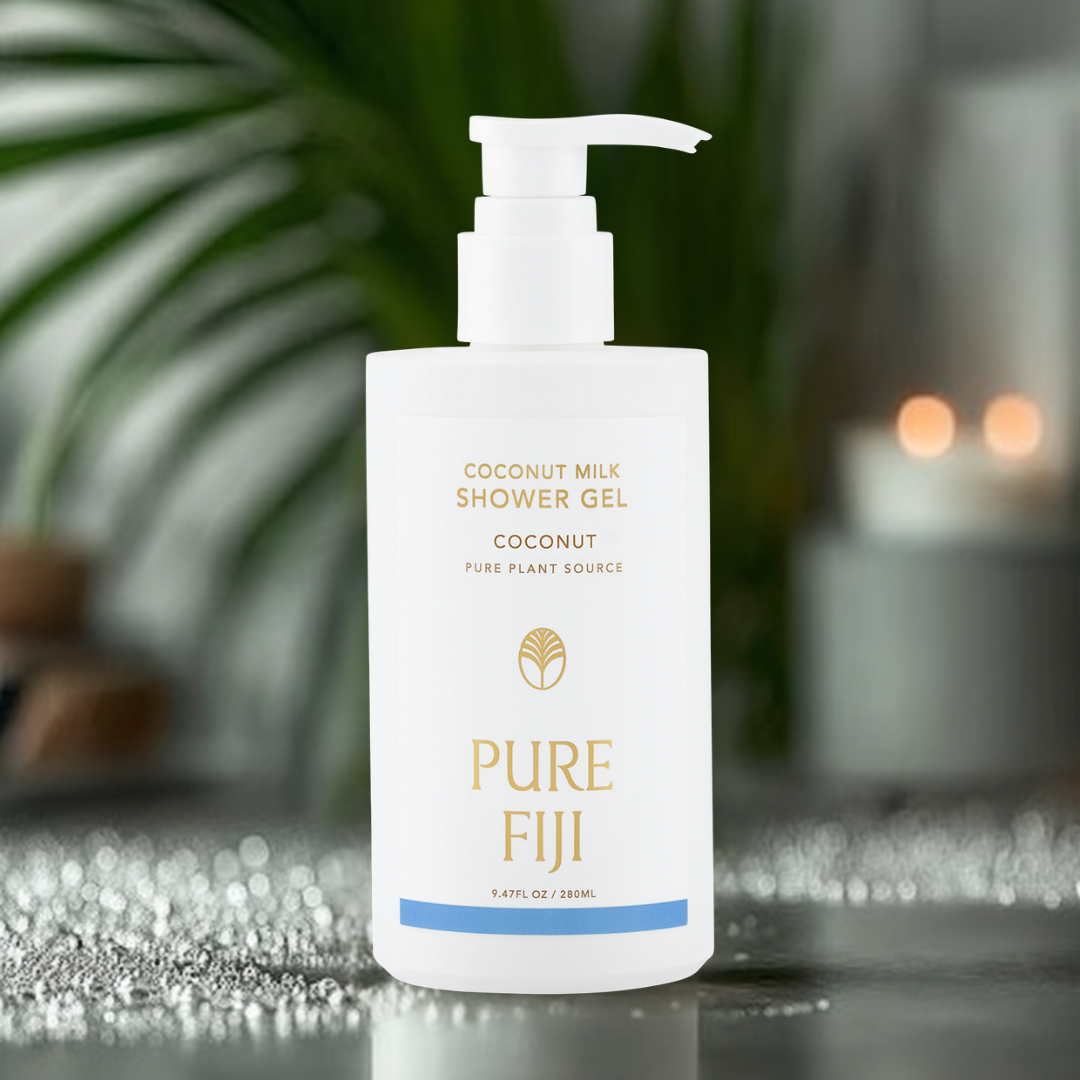 Pure Fiji coconut milk shower gel bottle on a reflective surface with blurred background