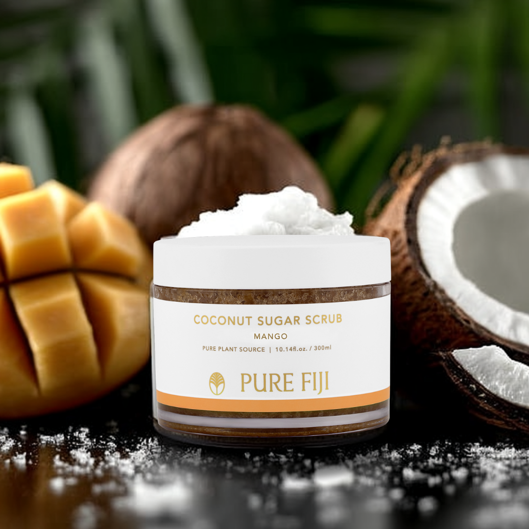 Jar of coconut sugar scrub with mango and coconut in the background