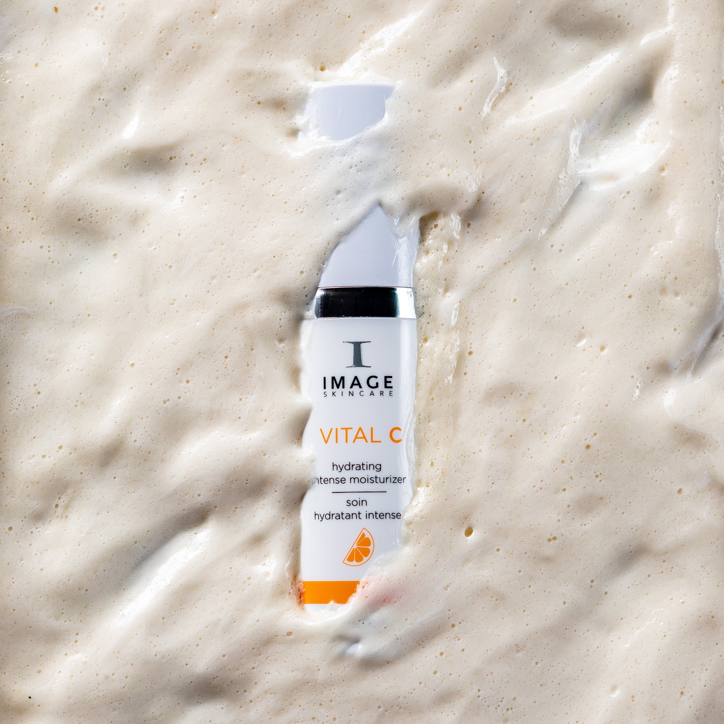 Skincare product labeled 'Image Skincare Vital C' on a textured cream background