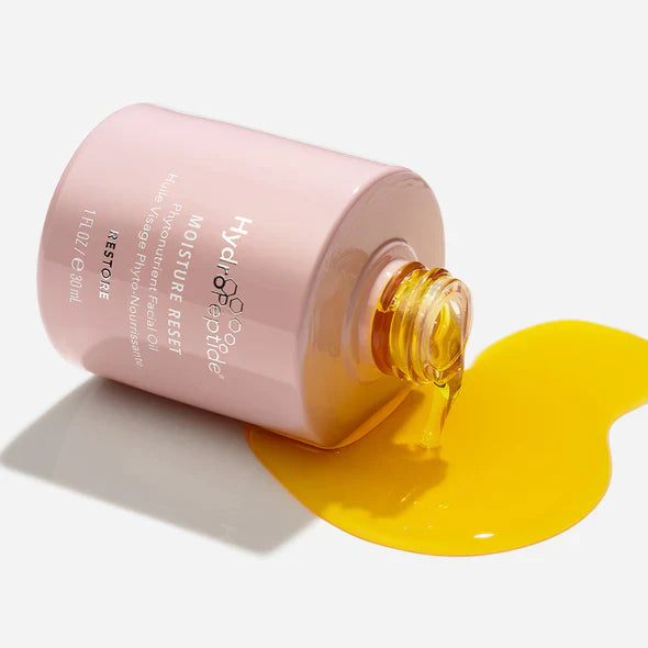 Pink bottle of Hydropeptide Moisture Reset with yellow liquid on a white background