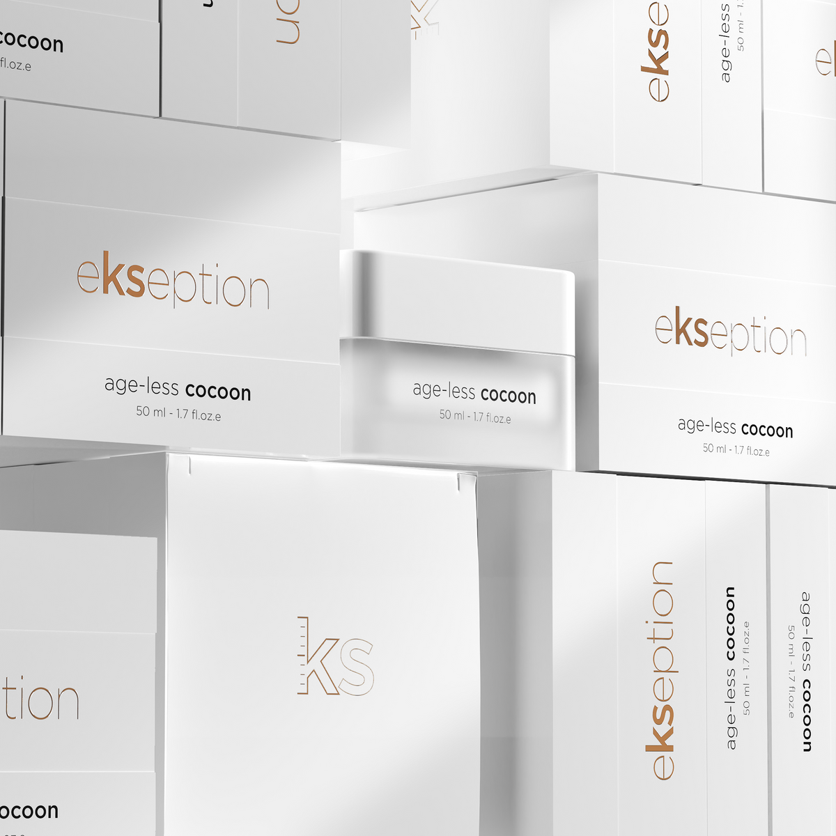 A stacked arrangement of white Ekseption skincare boxes and one open jar labeled age-less cocoon, with the brand name and product name clearly visible on the packaging.