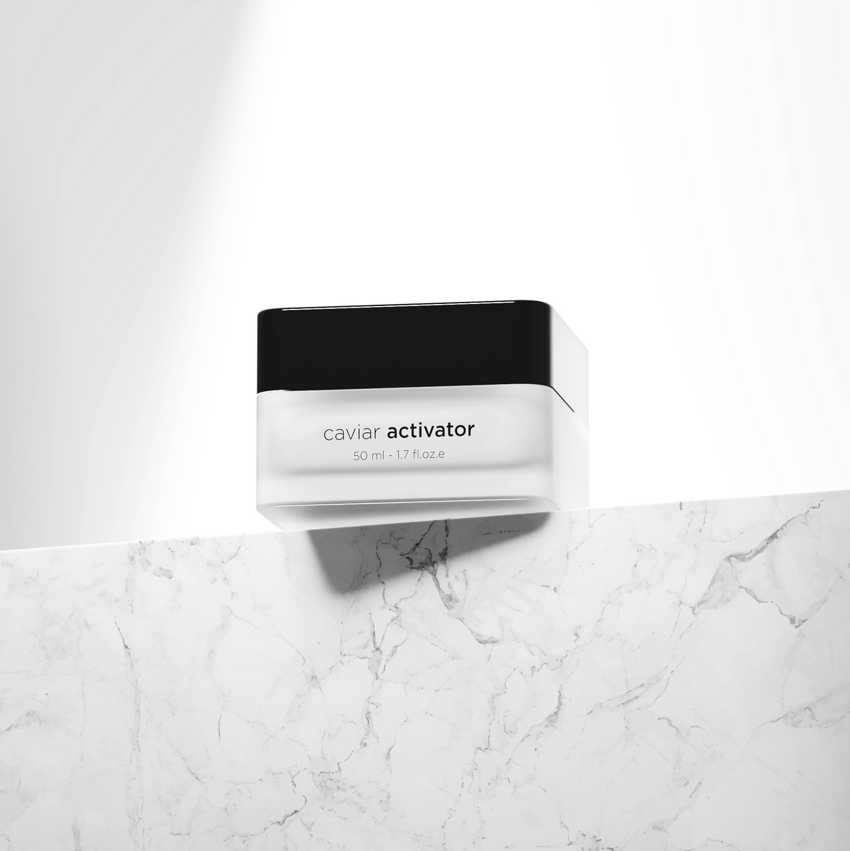 A single cosmetic jar labeled 'caviar activator' sits on a white marble surface against a white background with a dramatic diagonal light beam.