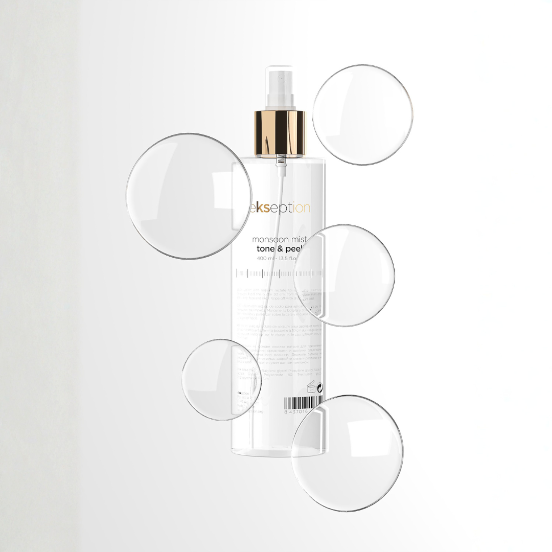 A clear bottle of Ekseption Monsoon Mist toning mist with a gold pump collar and white spray top, centered on a white background with several transparent bubble overlays.