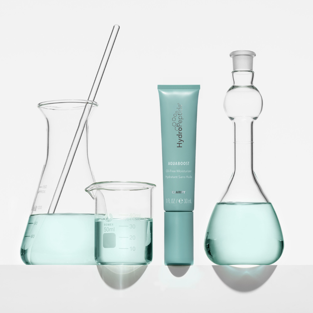 Scientific beakers with liquid and a tube labeled 'Aquaboost' on a white background