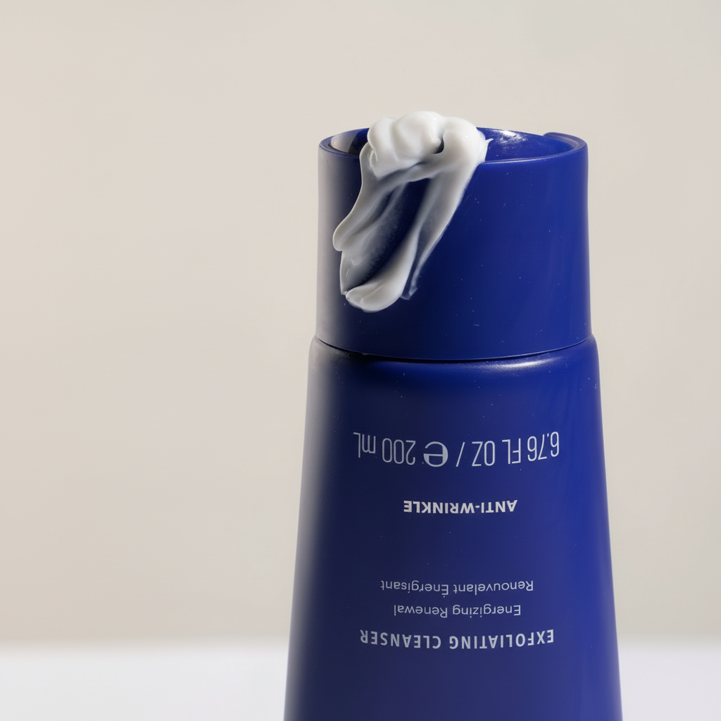 Blue skincare bottle with a white cap on a light gray background