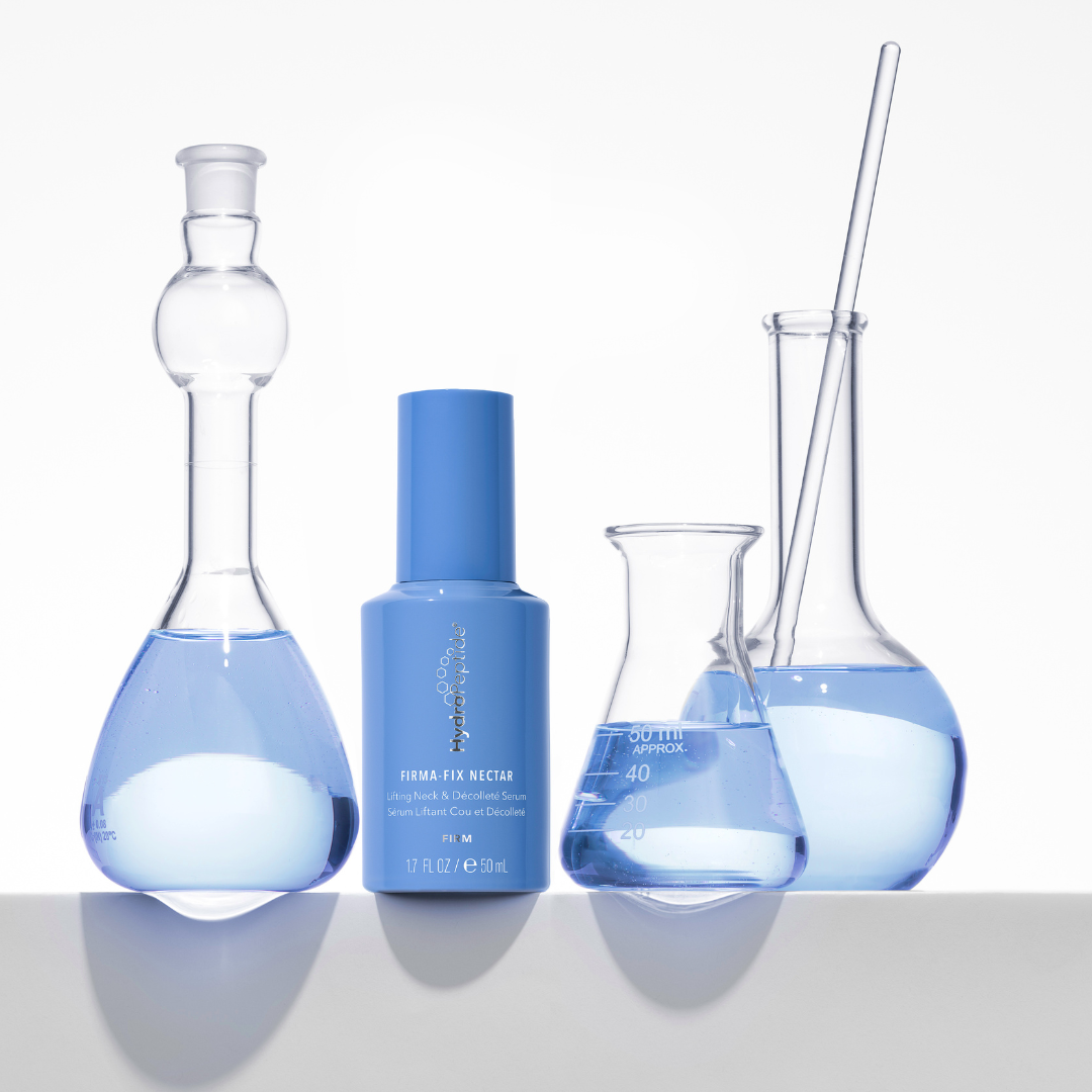 Blue skincare product with glass flasks containing blue liquid on a white background