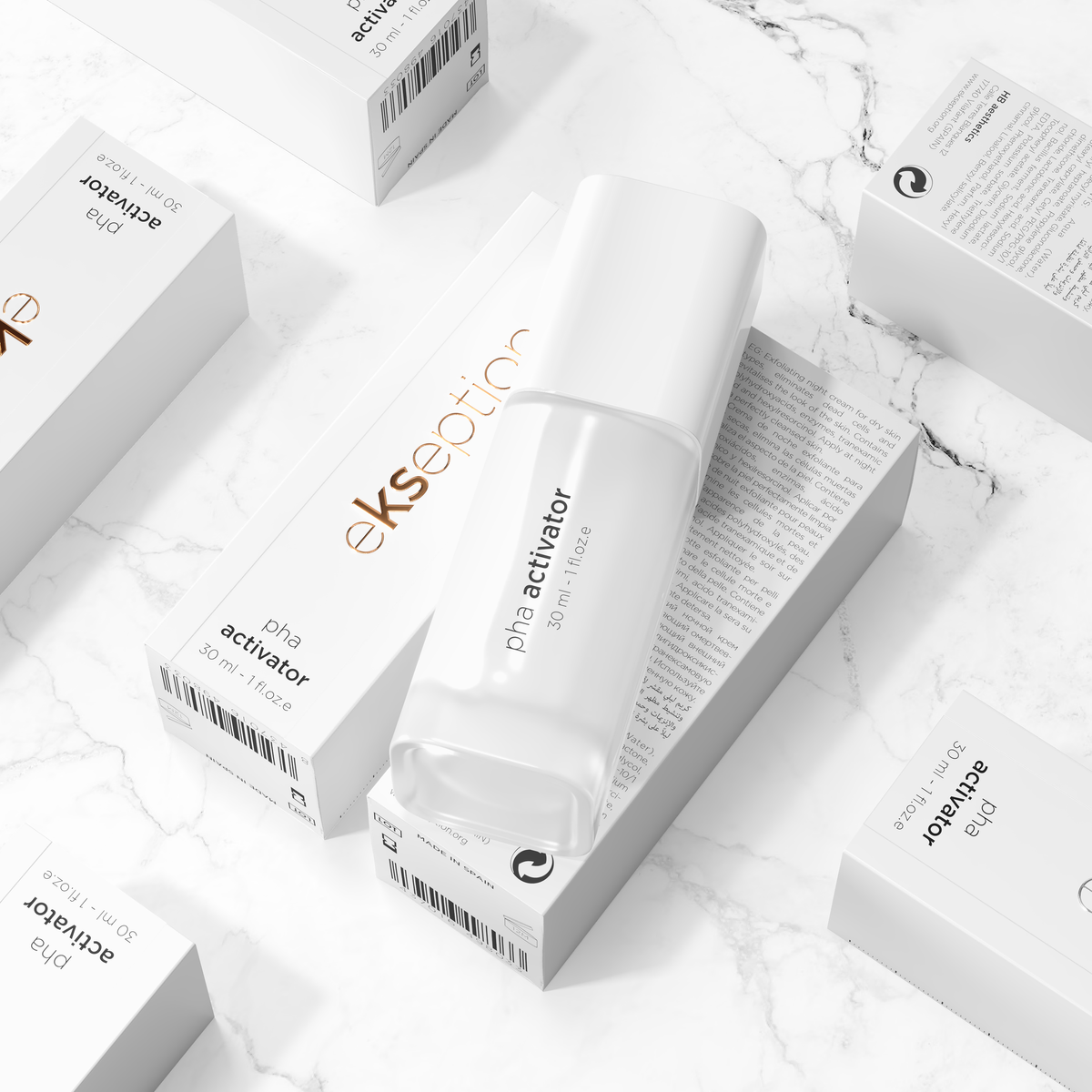 A skincare product bottle labeled 'eksection pha activator' arranged on top of several matching white product boxes on a light marble surface.