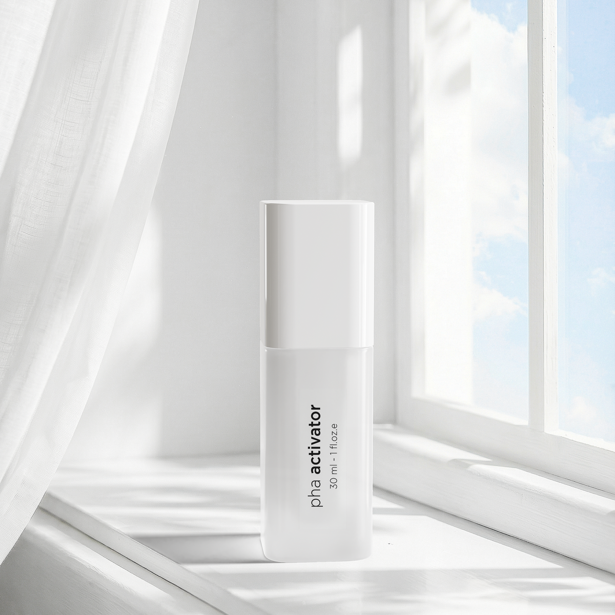 A white cylindrical cosmetic bottle labeled 'pha activator' sits on a sunlit windowsill with sheer white curtains and a bright window background.