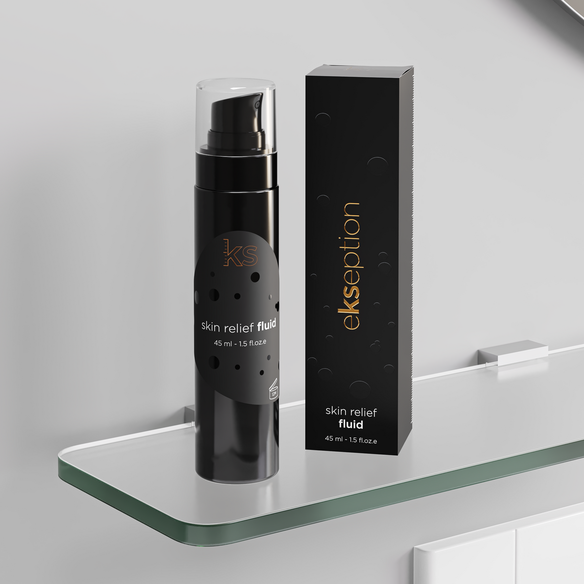 A black cosmetic pump bottle labeled 'ekseption skin relief fluid' stands next to its matching black rectangular box with gold text, displayed on a clear glass shelf against a light gray wall.