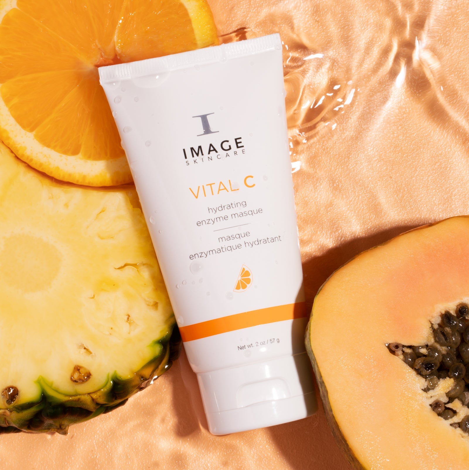 Tube of Image Skincare Vital C on a peach background with fruit slices