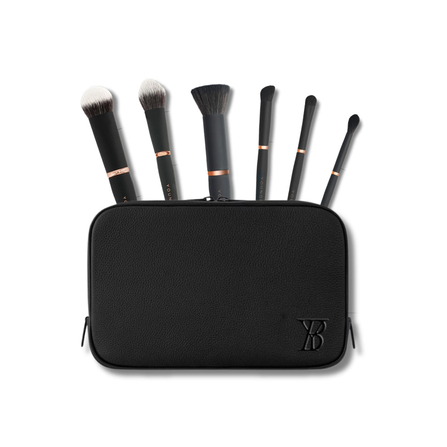Set of Youngblood Mineral makeup brushes in a black case on a white background