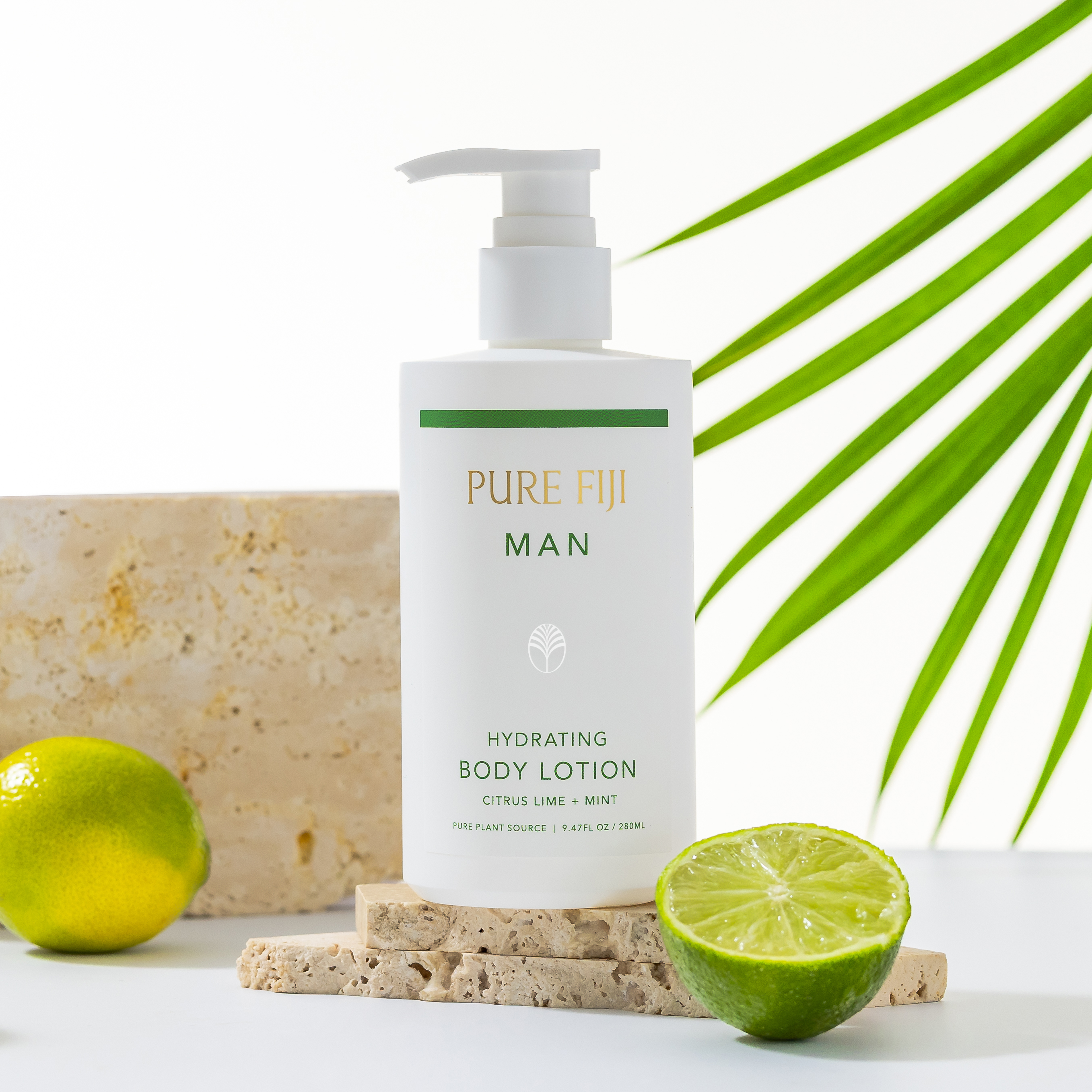 Pure Fiji Man hydrating body lotion with limes and a palm leaf on a white background